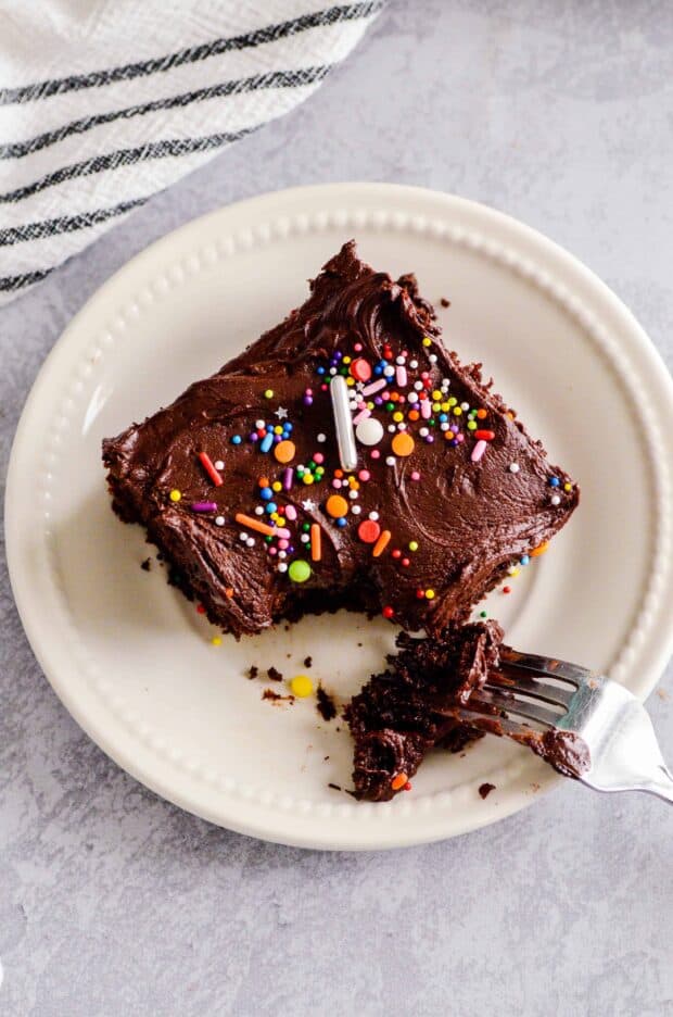 The Best Doctored Up Cake Mix Cake is the BEST CAKE OF ALL TIME EVER. Moist, fluffy, and topped with a supremely fudgy chocolate frosting.