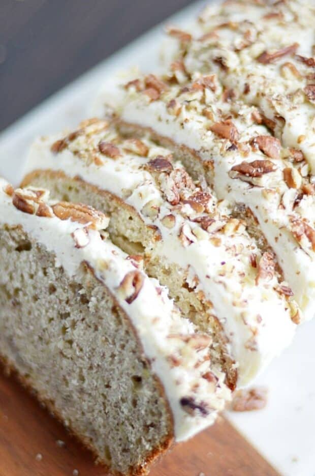 My favorite classic banana bread recipe smothered in cream cheese frosting and chopped pecans.