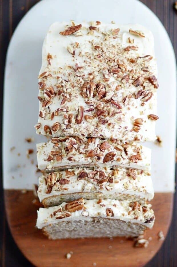 My favorite classic banana bread recipe smothered in cream cheese frosting and chopped pecans.