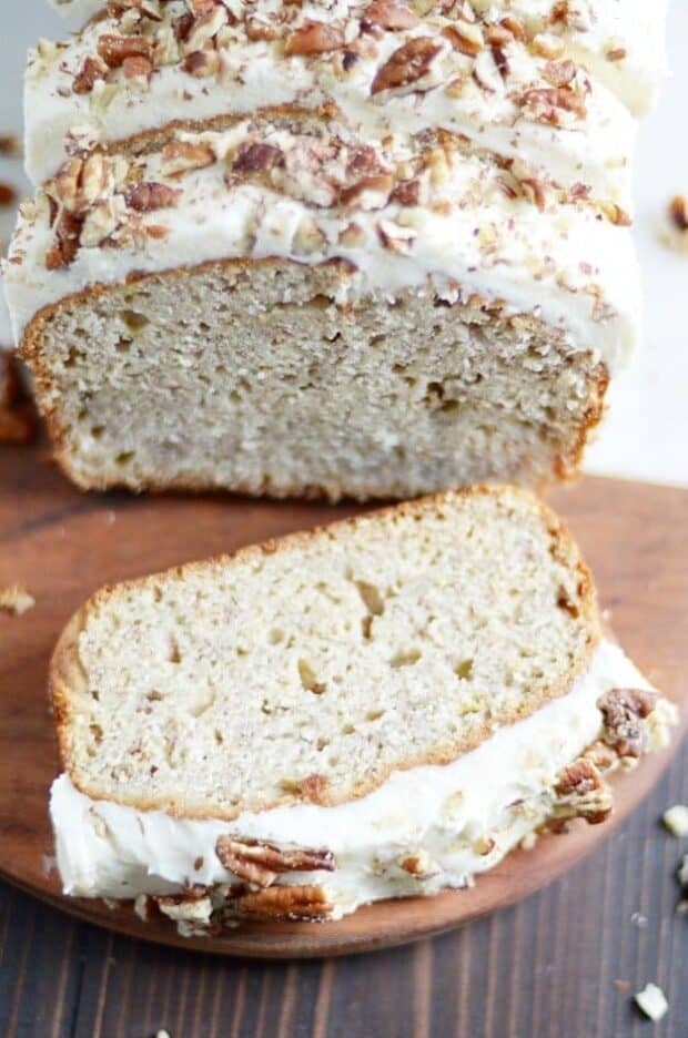 My favorite classic banana bread recipe smothered in cream cheese frosting and chopped pecans.