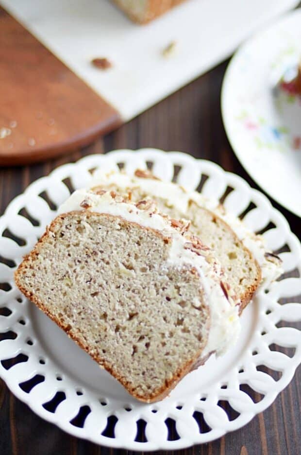 My favorite classic banana bread recipe smothered in cream cheese frosting and chopped pecans.