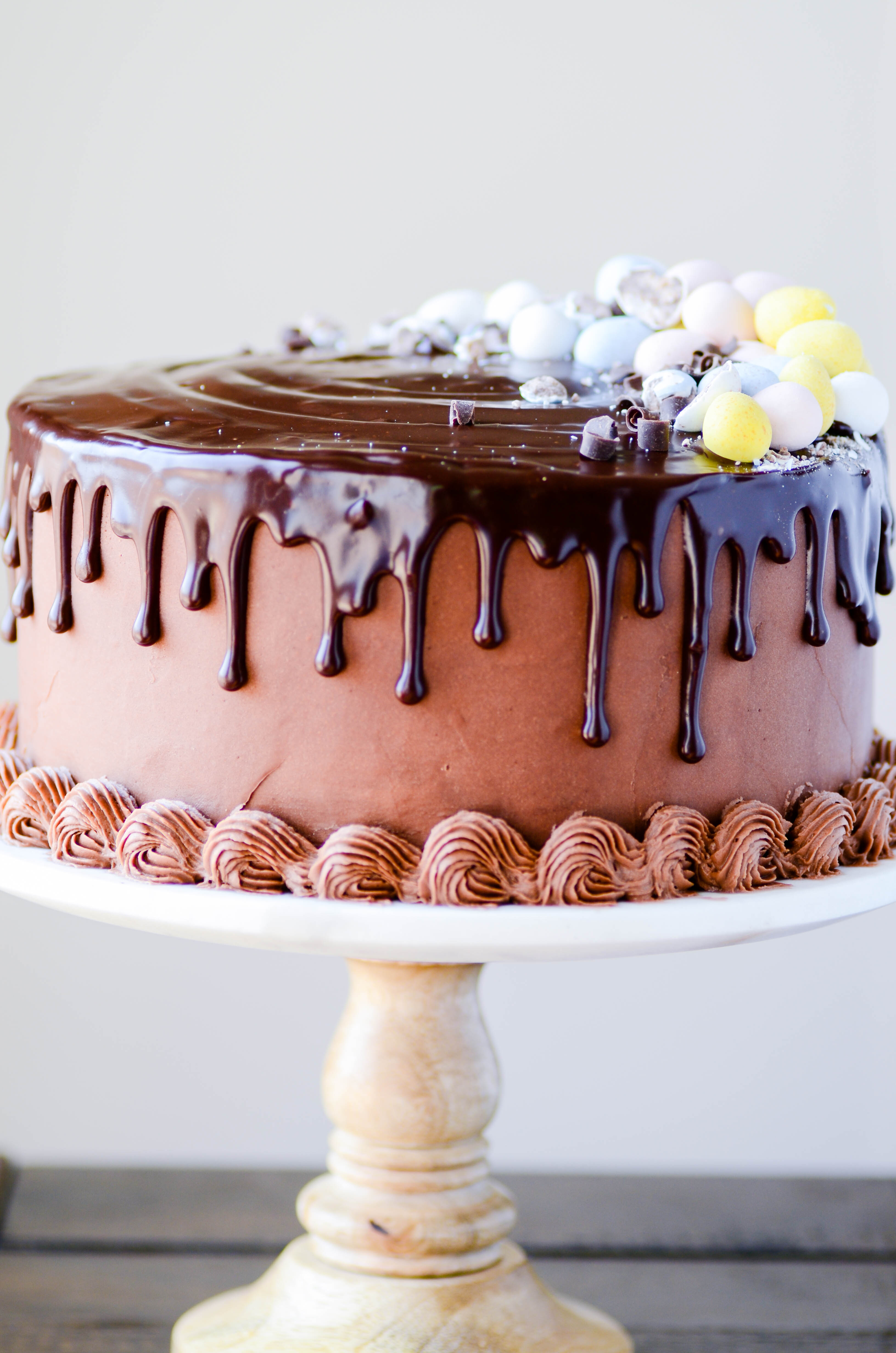 A mini cadbury egg cheesecake in between two layers of my favorite chocolate cake. Frosted with milk chocolate buttercream and topped with chocolate ganache!