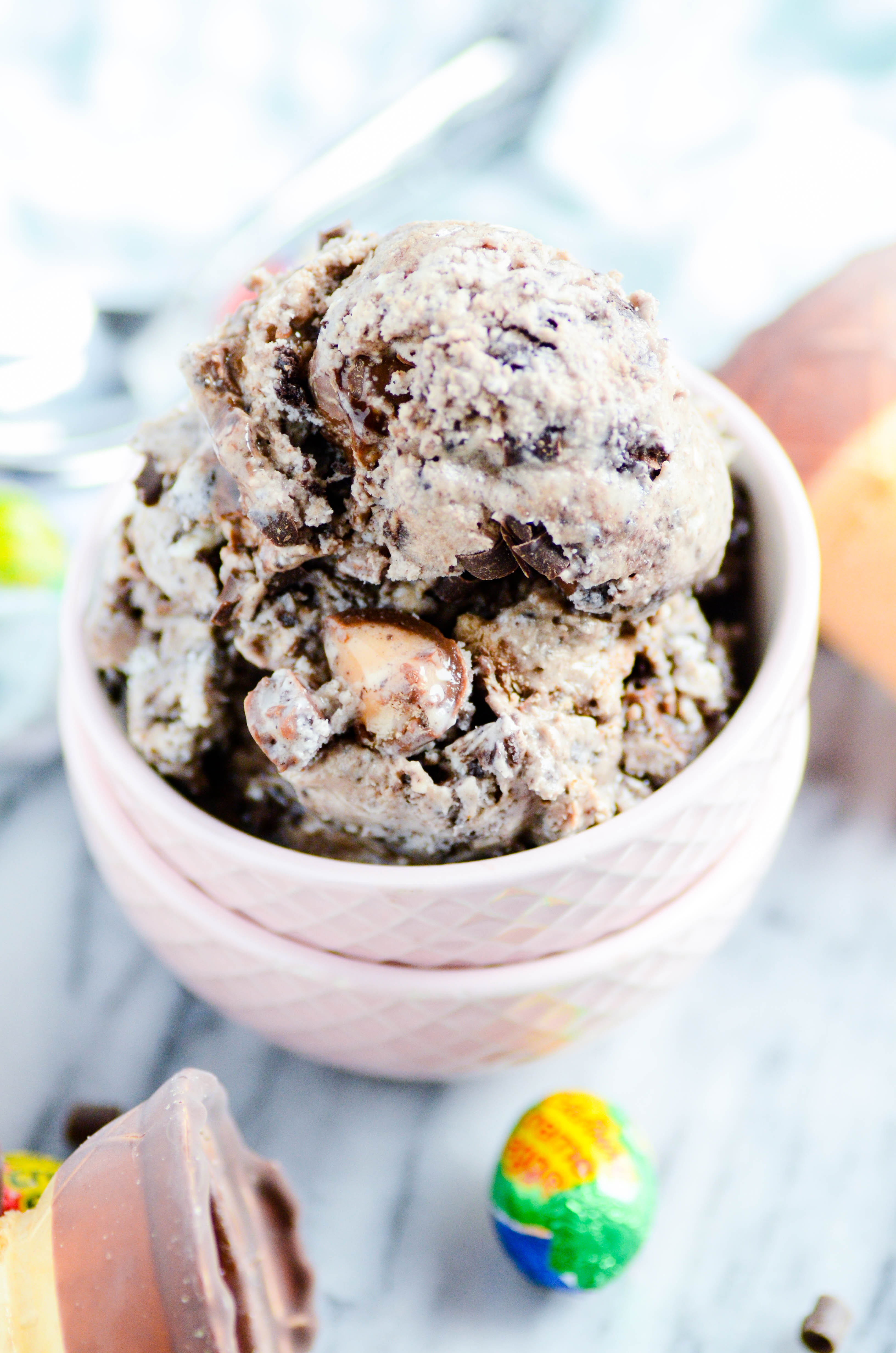 Creamy Oreo ice cream with mini Cadbury Cream Eggs and swirls of hot fudge. No machine required and a way better texture than other no-churn recipes!