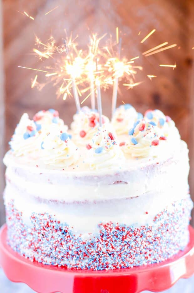 Fun and festive red (and blue) velvet layers of cake complete with cream cheese frosting and a fun surprise candy filling!