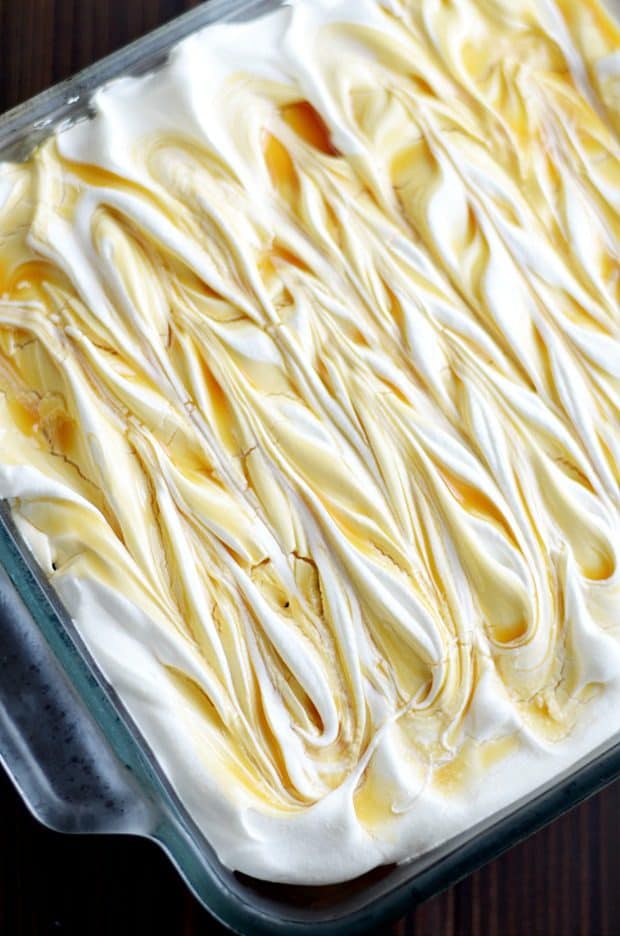 Yellow cake soaked in cheesecake pudding and salted caramel, topped with Cool Whip and a salted caramel swirl.