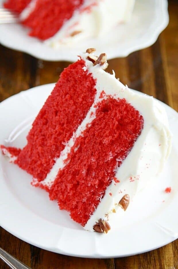 Supremely moist and delicious Red Velvet Cake with cream cheese frosting. Cake Man Raven with chopped Pecans. Yum.
