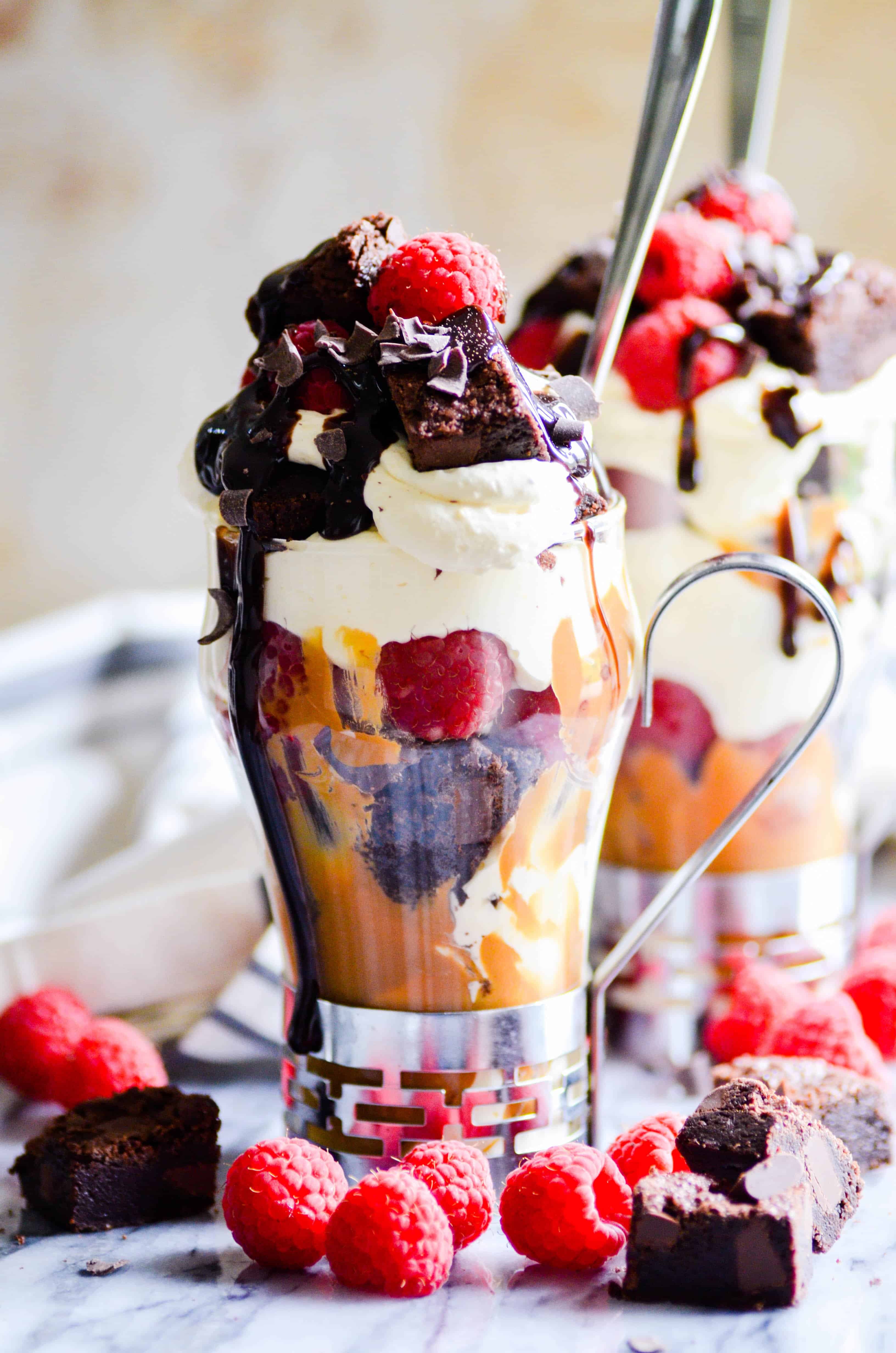This Raspberry Brownie Parfait has layers of fudgy brownie bites, creamy cheesecake mousse, juicy raspberries, and a swirl of Biscoff cookie spread.