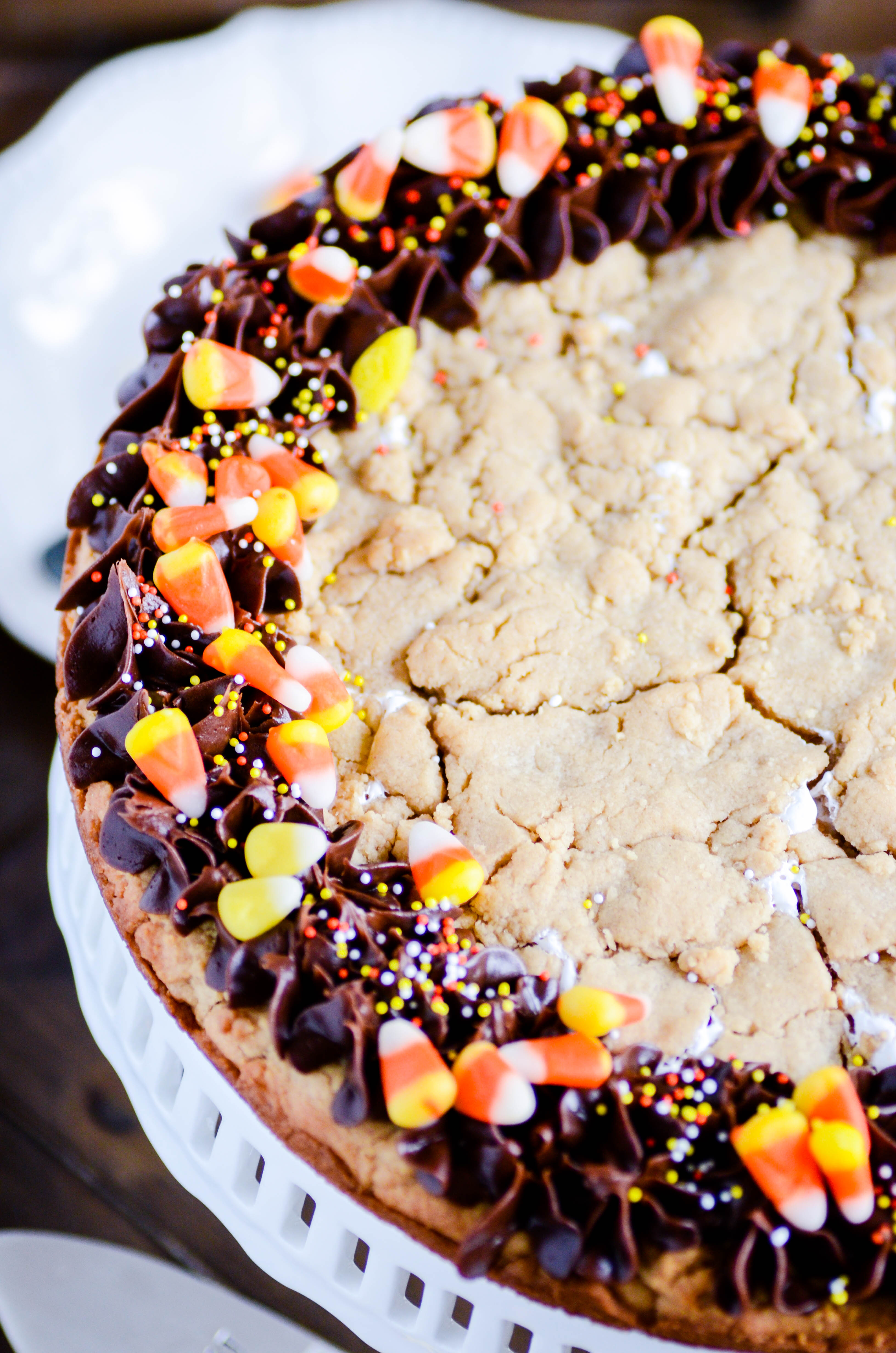 A peanut butter cookie the size of a cake filled with marshmallow cream! Topped with chocolate frosting and candy corn. Slice and serve!