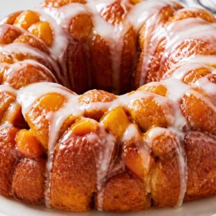 This peach monkey bread is gooey, dreamy pull-apart perfection loaded with juicy peaches — your new summer breakfast obsession! 🍑