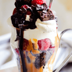 This Raspberry Brownie Parfait has layers of fudgy brownie bites, creamy cheesecake mousse, juicy raspberries, and a swirl of Biscoff cookie spread.