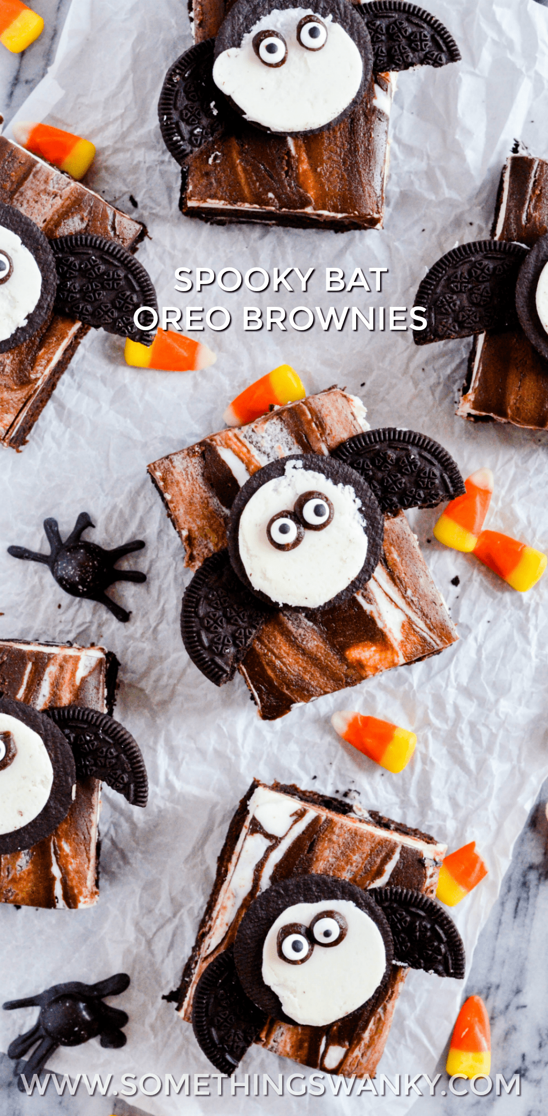 Fudgy brownies with a layer of Oreos in the middle topped with a whipped vanilla buttercream, fudge sauce, and another Oreo for good measure.